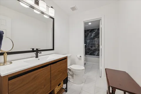 a bathroom with a sink vanity and mirror