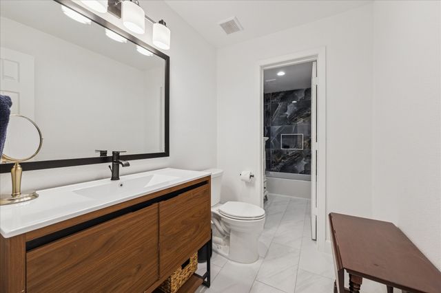 a bathroom with a sink vanity and mirror