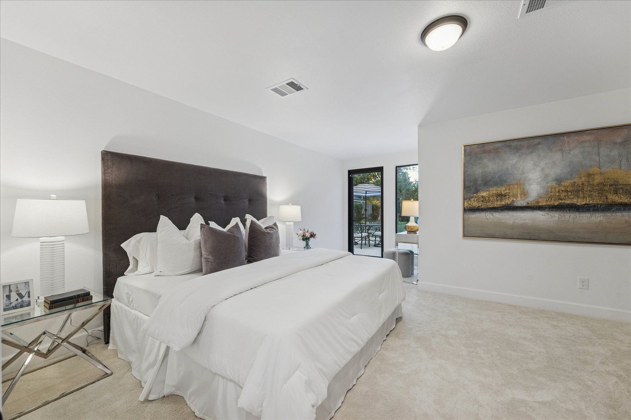 45 Patti Lynn Lane Houston, TX 77024 - Photo 28 of 49 a bedroom with a large bed and a painting on the wall