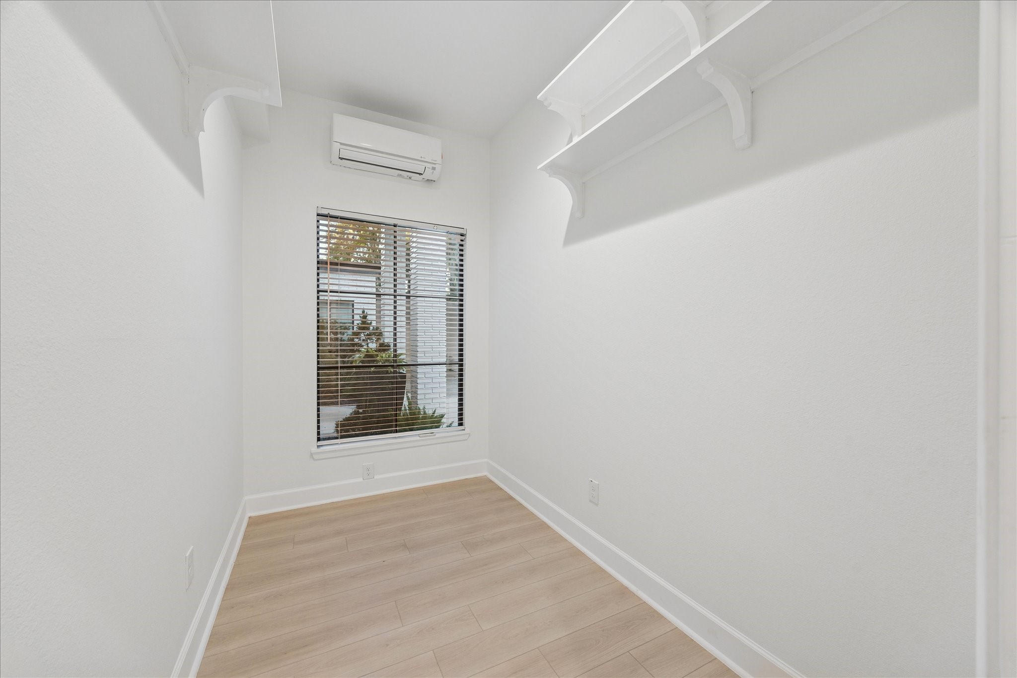 45 Patti Lynn Lane Houston, TX 77024 - Photo 35 of 49 a view of an empty room with wooden floor and a window