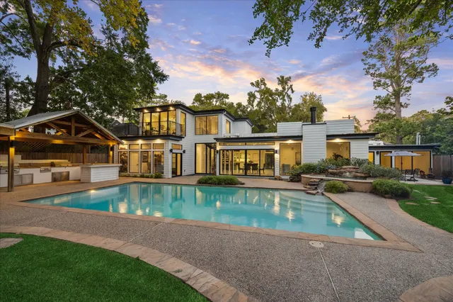 a view of a house with pool yard and sitting area