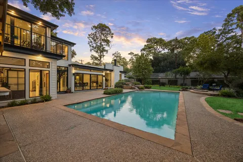 a view of a backyard with large trees