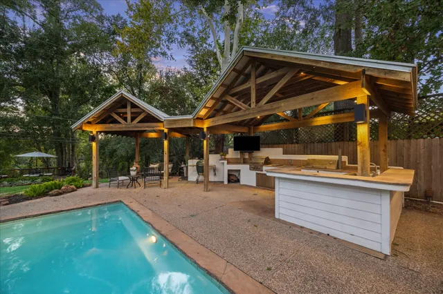 a lake view with a bench and trees around