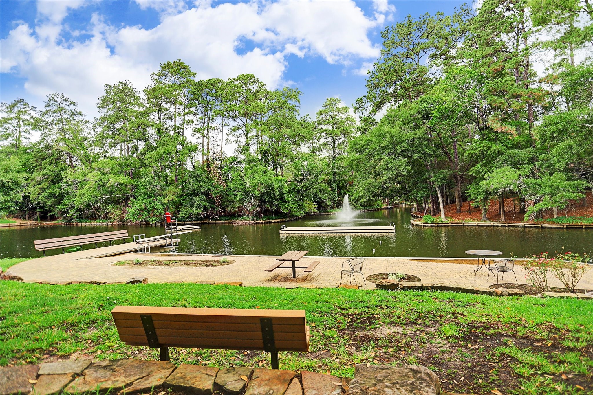 45 Patti Lynn Lane Houston, TX 77024 - Photo 48 of 49 a lake view with a bench and trees around