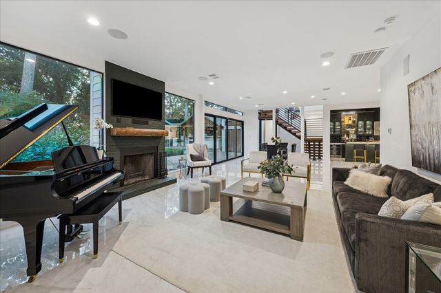 a kitchen with stainless steel appliances kitchen island granite countertop a refrigerator and cabinets