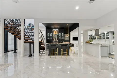 a kitchen with kitchen island granite countertop lots of counter top space and stainless steel appliances
