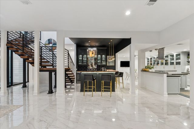 a kitchen with kitchen island granite countertop lots of counter top space and stainless steel appliances