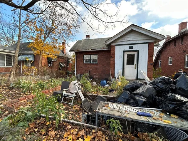 a view of a house with a yard and plants