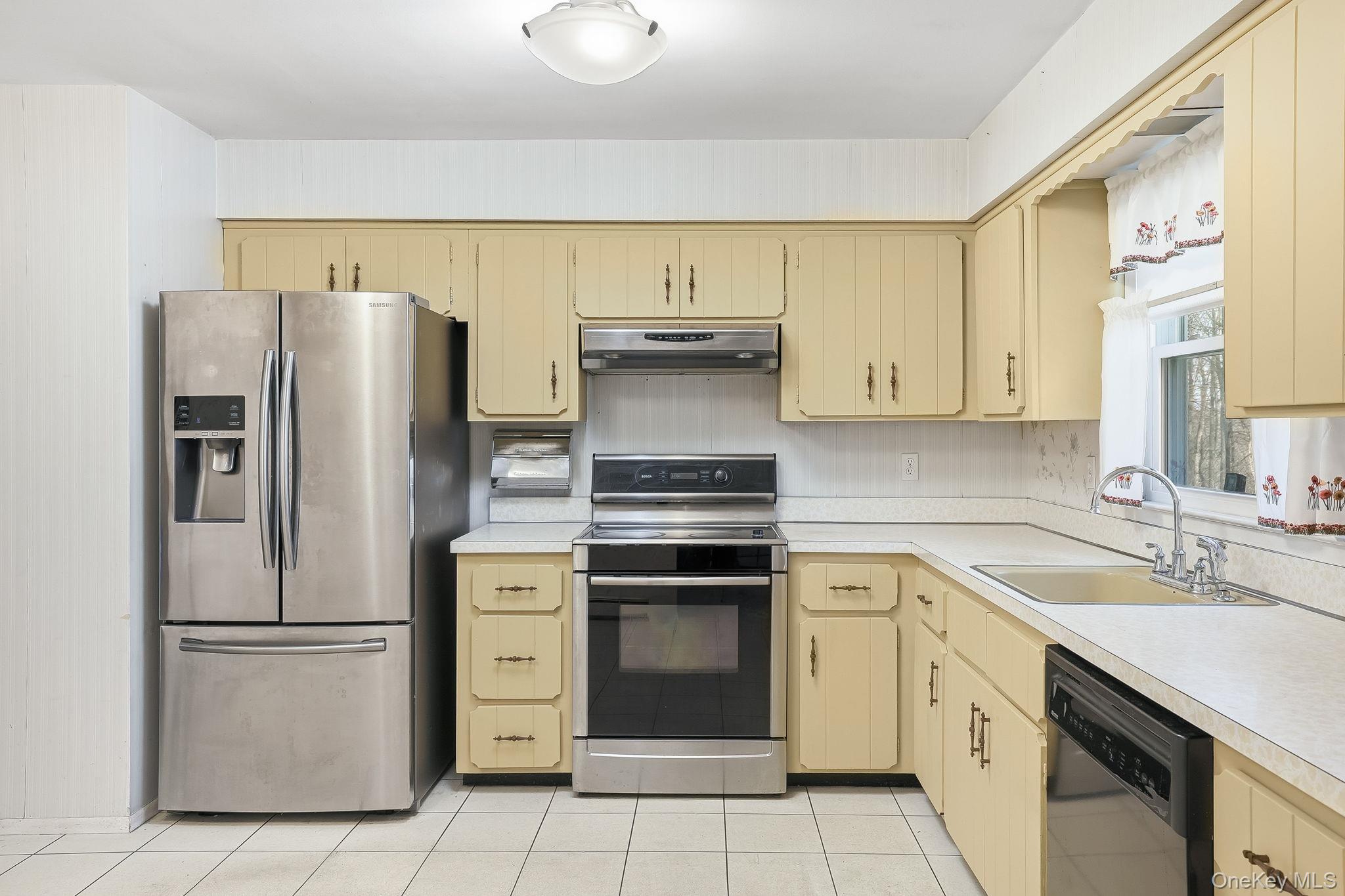 42 Bayberry Hill Road Mahopac, NY 10541 - Photo 12 of 49 Kitchen featuring stainless steel appliances, cream cabinets, and light countertops