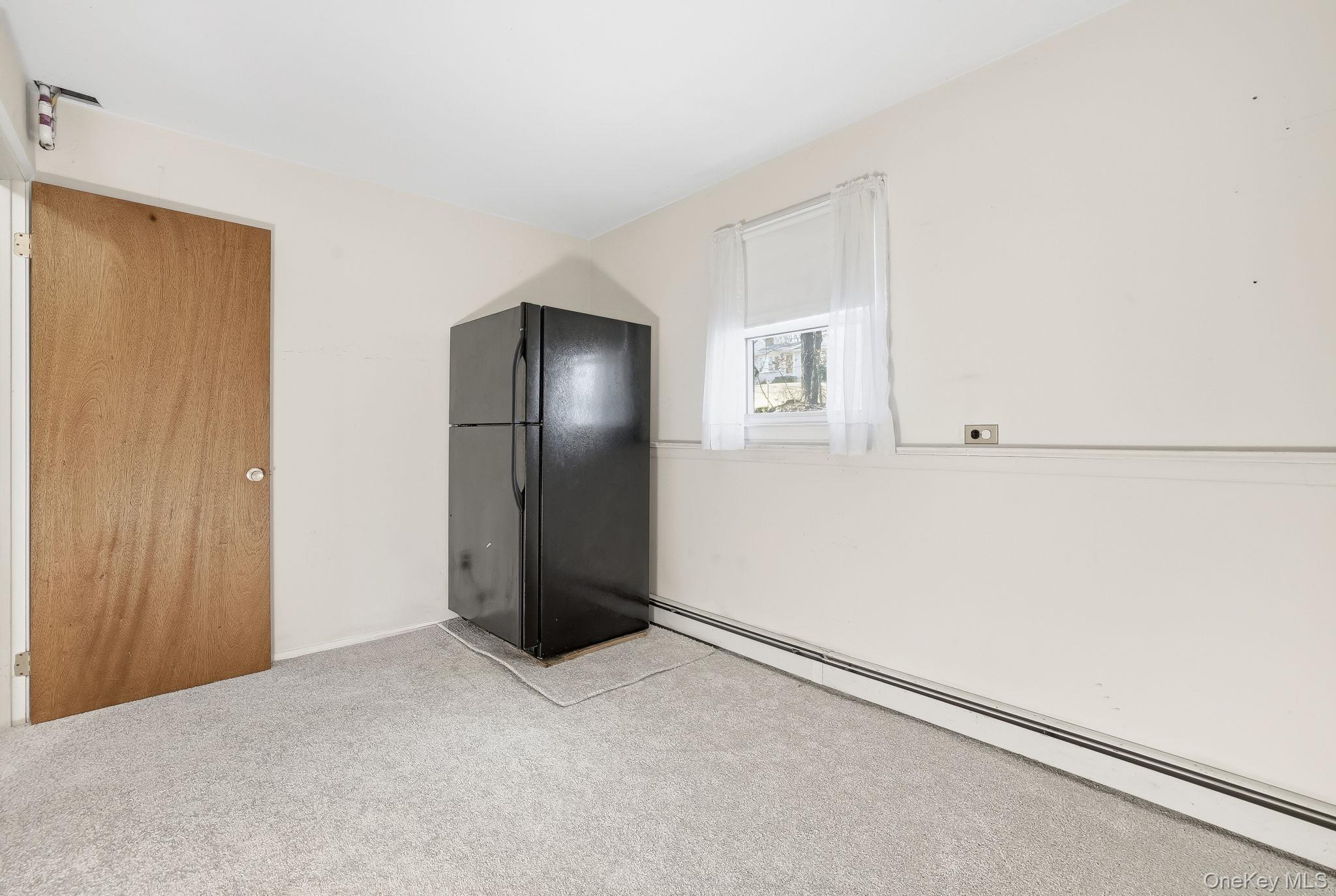 42 Bayberry Hill Road Mahopac, NY 10541 - Photo 32 of 49 Spare room featuring baseboard heating and carpet flooring