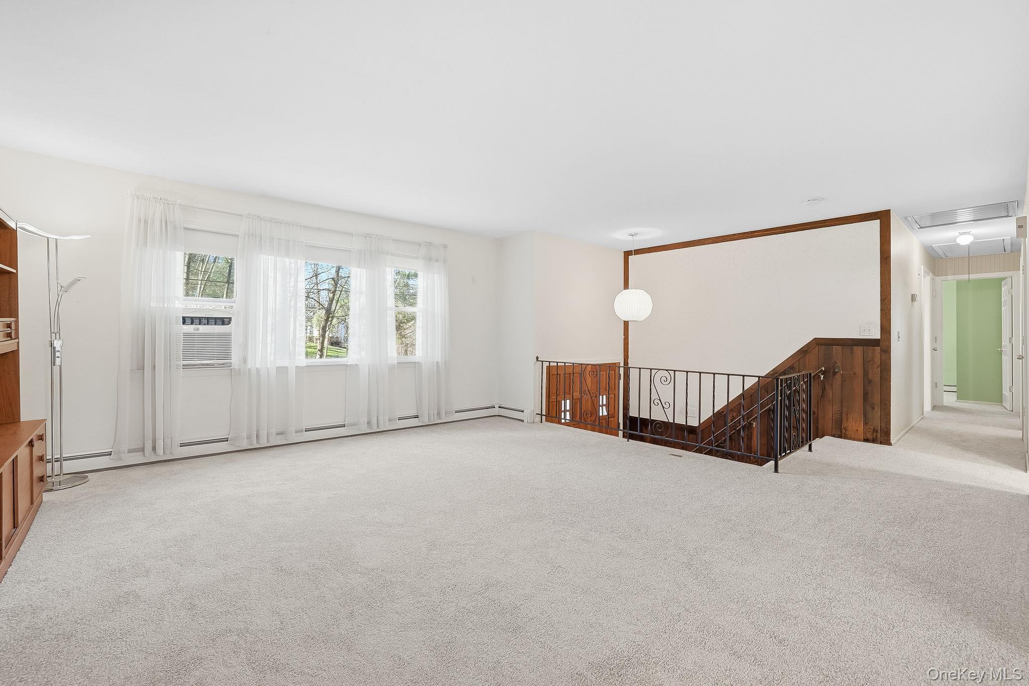 42 Bayberry Hill Road Mahopac, NY 10541 - Photo 4 of 49 Carpeted empty room featuring attic access, a baseboard heating unit, and cooling unit