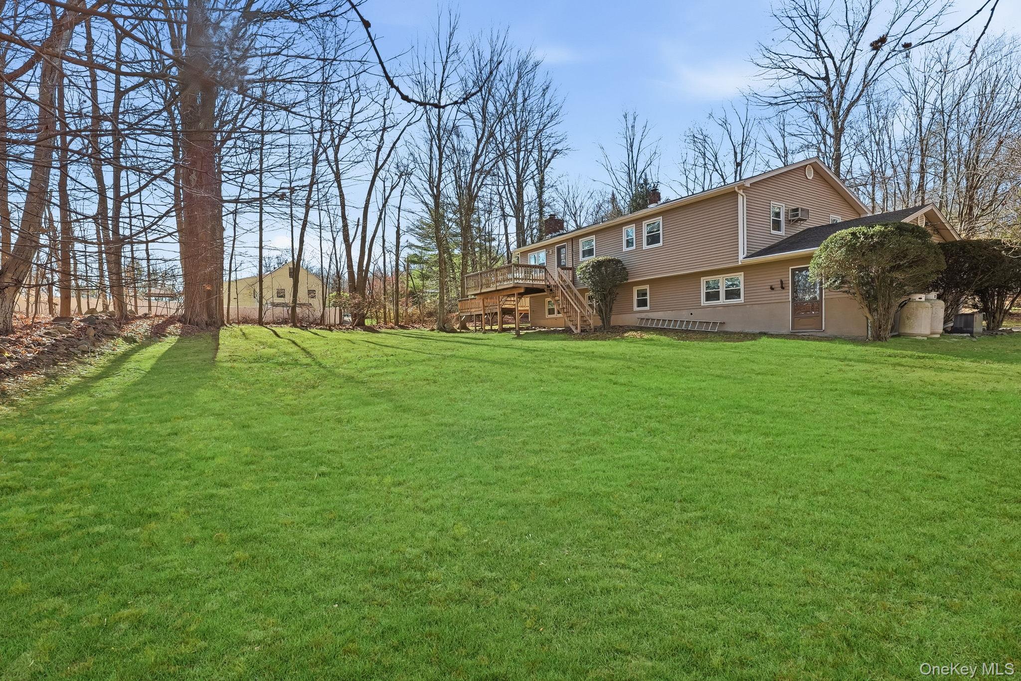 42 Bayberry Hill Road Mahopac, NY 10541 - Photo 41 of 49 View of grassy yard featuring a deck and stairs