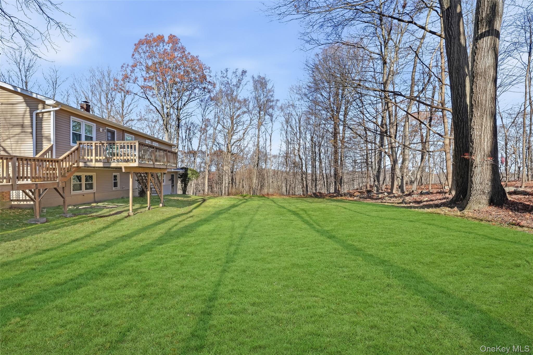 42 Bayberry Hill Road Mahopac, NY 10541 - Photo 47 of 49 View of green lawn featuring a wooden deck and stairway