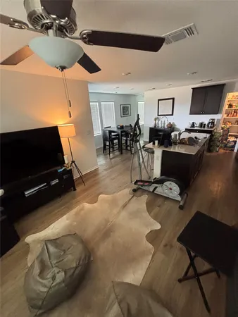 a living room with furniture gym equipment and a flat screen tv