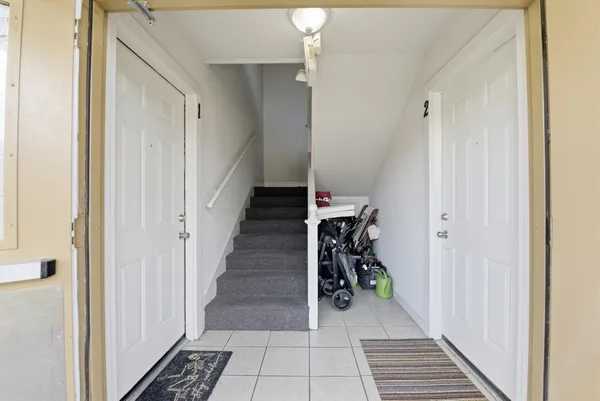 a view of a hallway with a dining area closet and front door