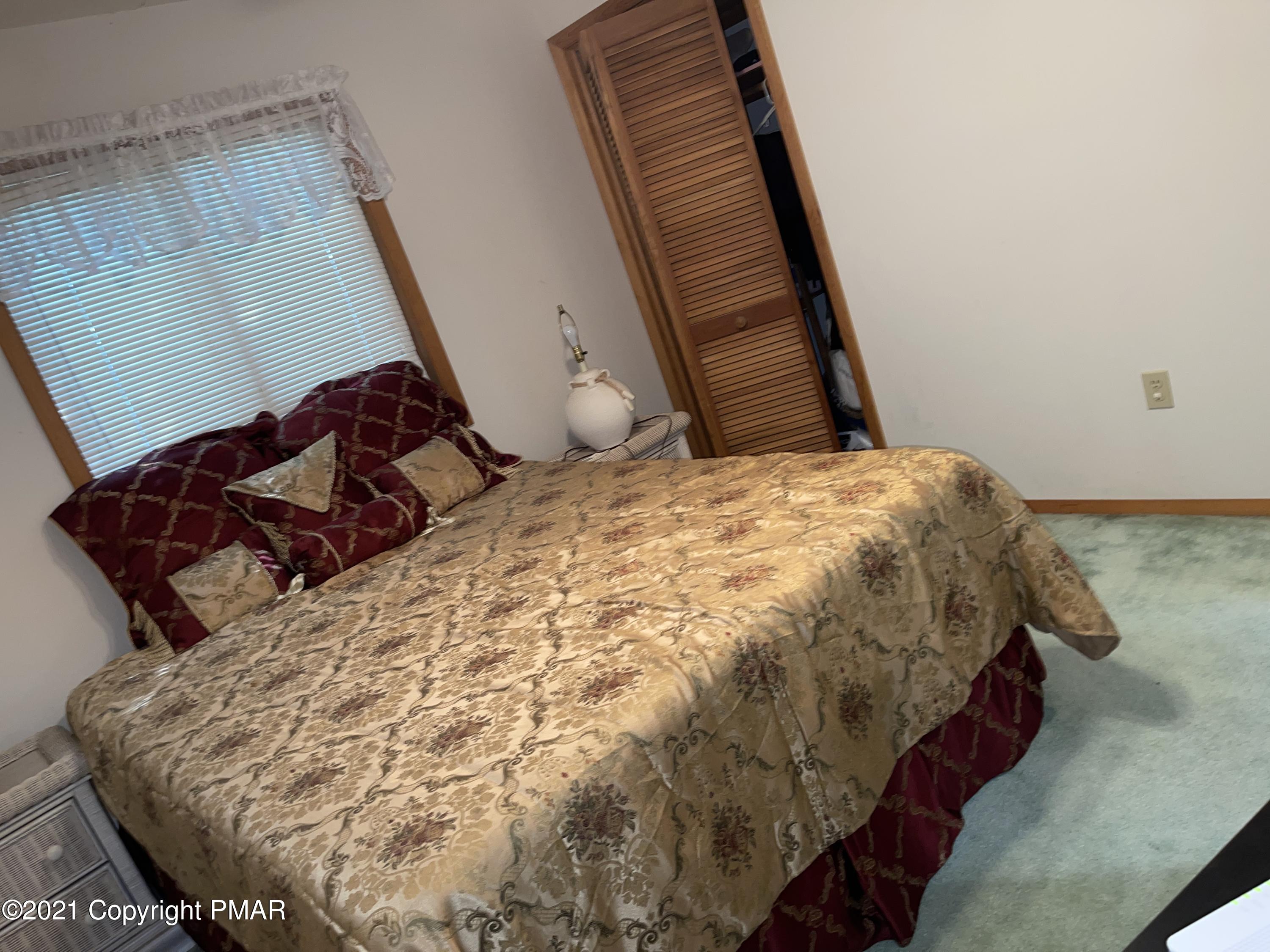 139 Dunchurch Drive Bushkill, PA 18324 - Photo 13 of 37 a bed sitting in a bedroom next to a window