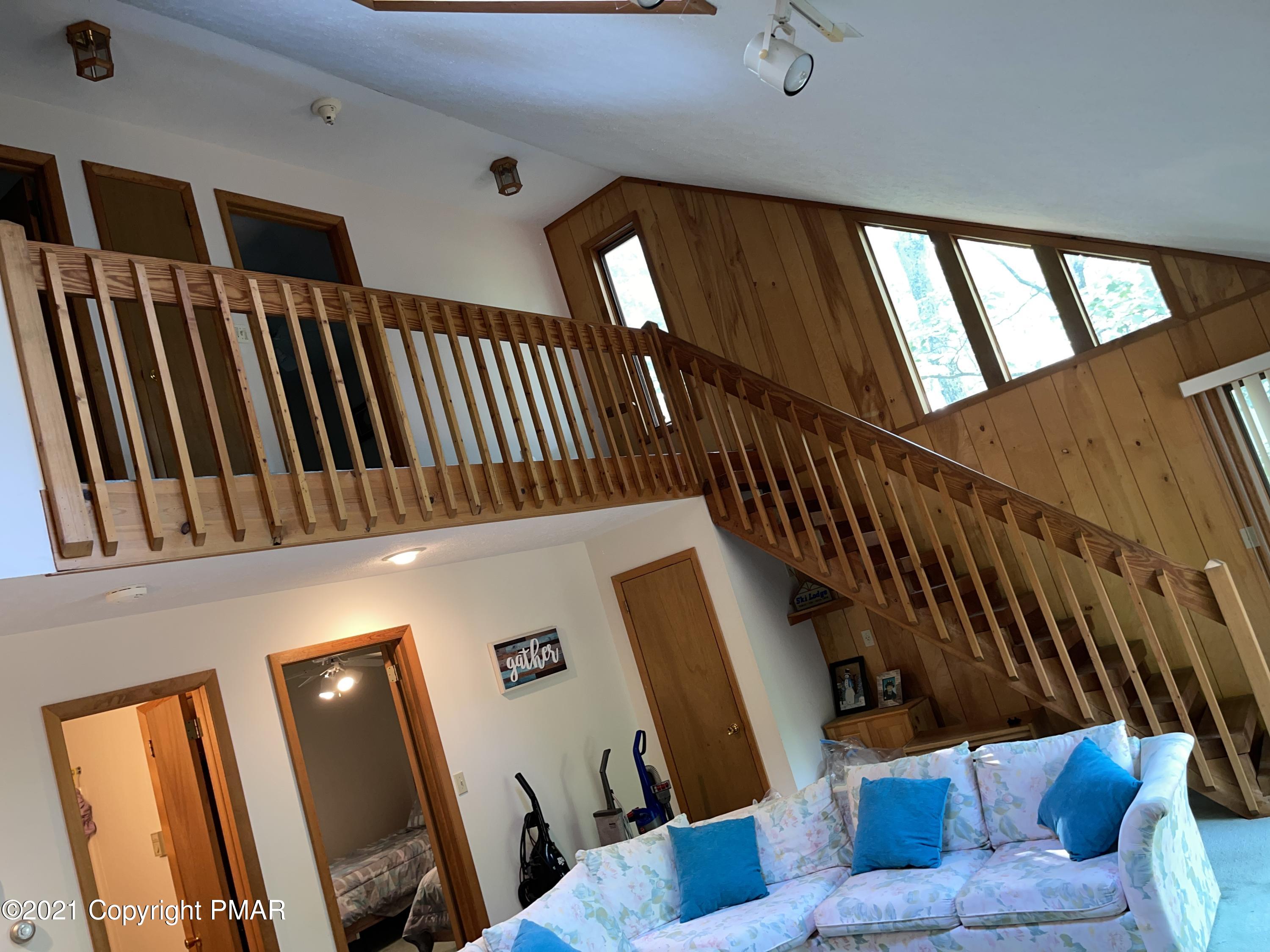 139 Dunchurch Drive Bushkill, PA 18324 - Photo 17 of 37 a view of staircase with wooden floor and windows