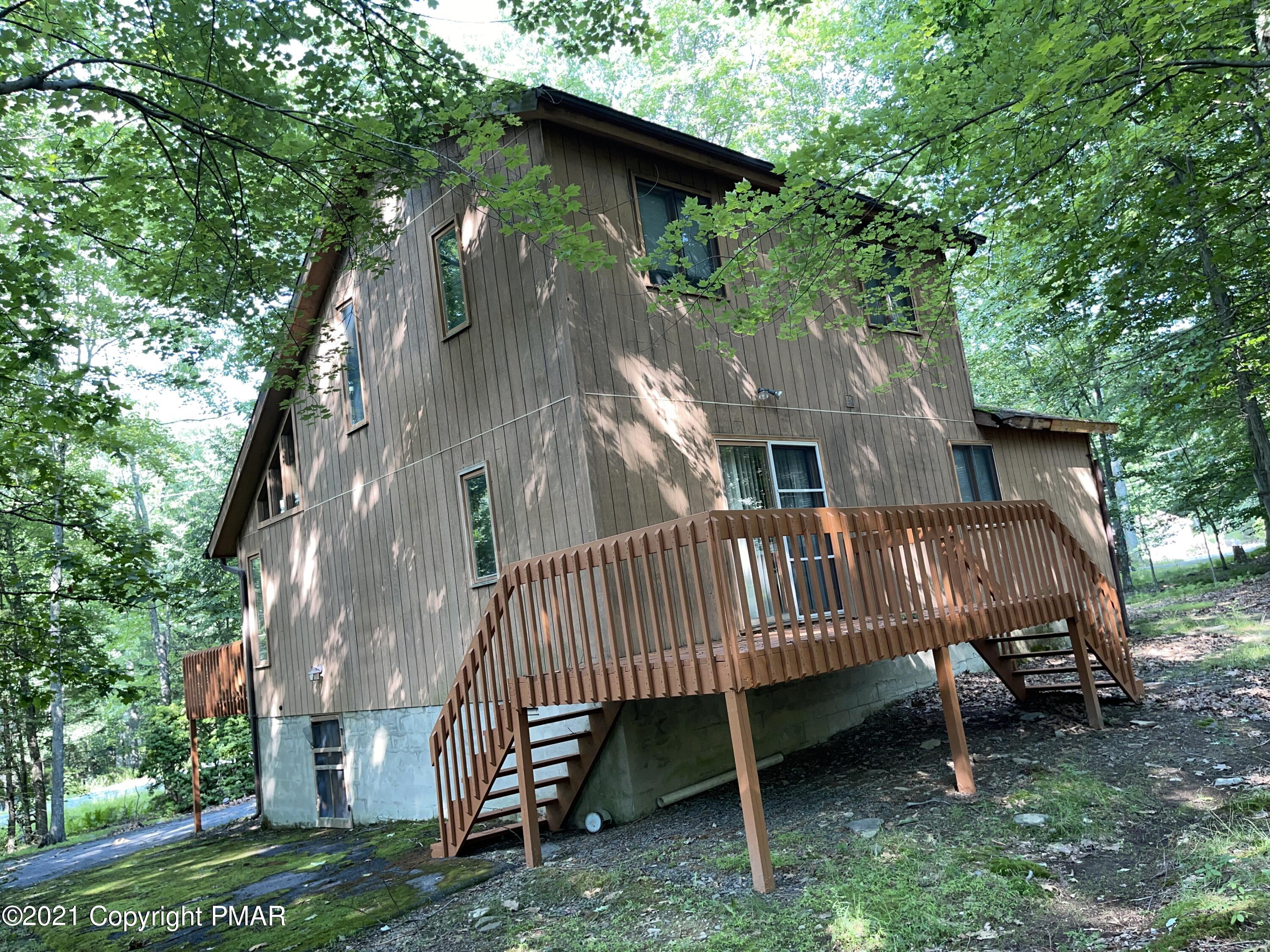 139 Dunchurch Drive Bushkill, PA 18324 - Photo 33 of 37 a view of a house with a yard and deck area under a large tree