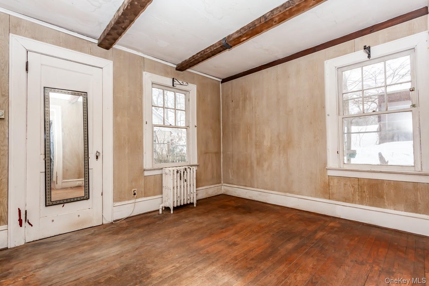 616 Union Avenue Peekskill, NY 10566 - Photo 14 of 39 an empty room with wooden floor and windows