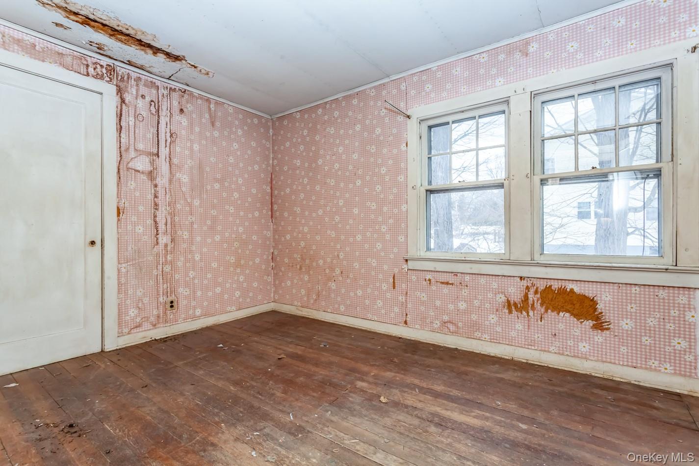 616 Union Avenue Peekskill, NY 10566 - Photo 16 of 39 an empty room with wooden floor and windows