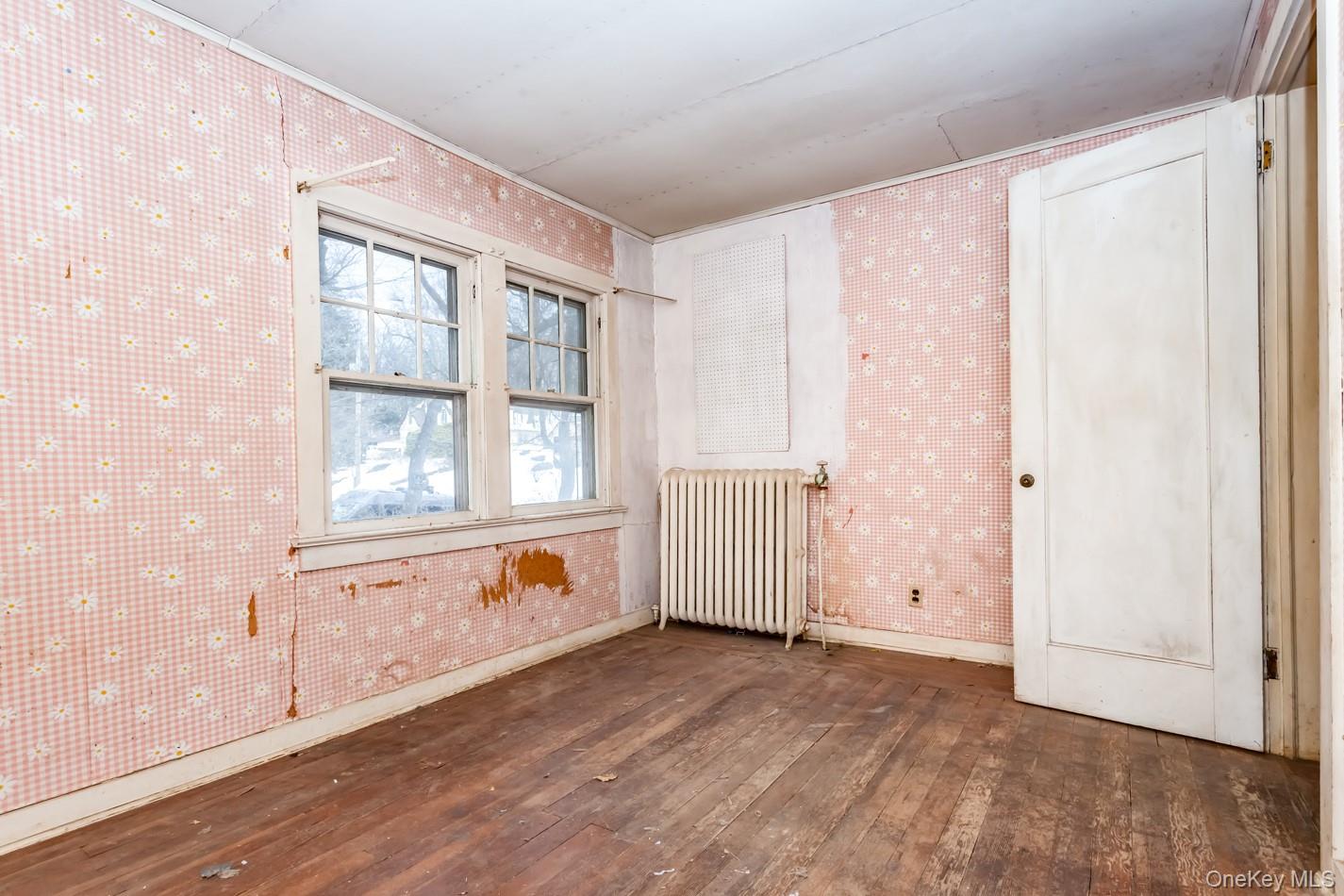 616 Union Avenue Peekskill, NY 10566 - Photo 17 of 39 an empty room with wooden floor and windows