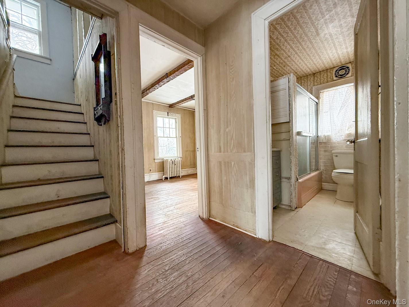 616 Union Avenue Peekskill, NY 10566 - Photo 10 of 39 a view of a hallway with wooden floor and staircase