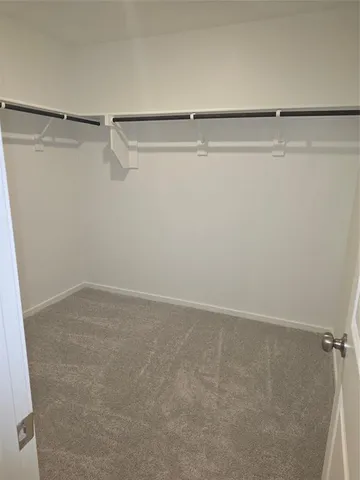 a view of an empty room with kitchen