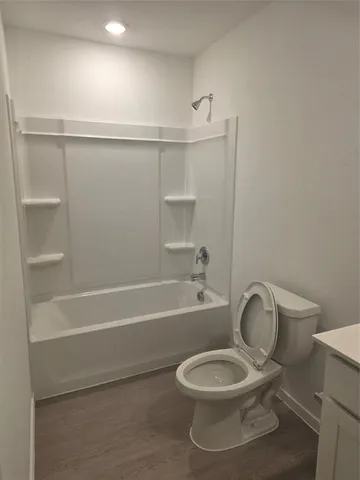 a bathroom with a toilet and a bathtub