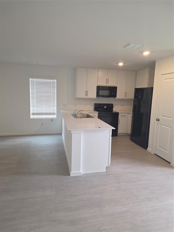 627 Montclair Avenue Princeton, TX 75407 - Photo 6 of 12 a kitchen with refrigerator and microwave