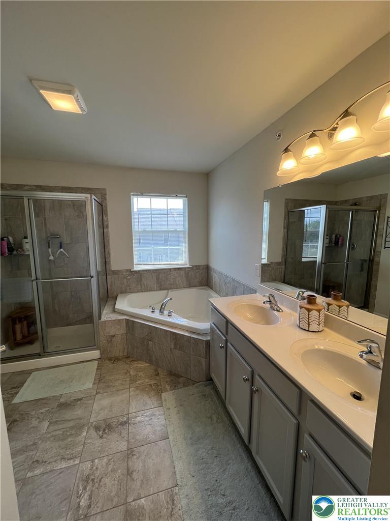 5380 Jutland Road Allentown, PA 18104 - Photo 21 of 27 Luxurious bathing retreat featuring a spacious corner tub and dual vanities.