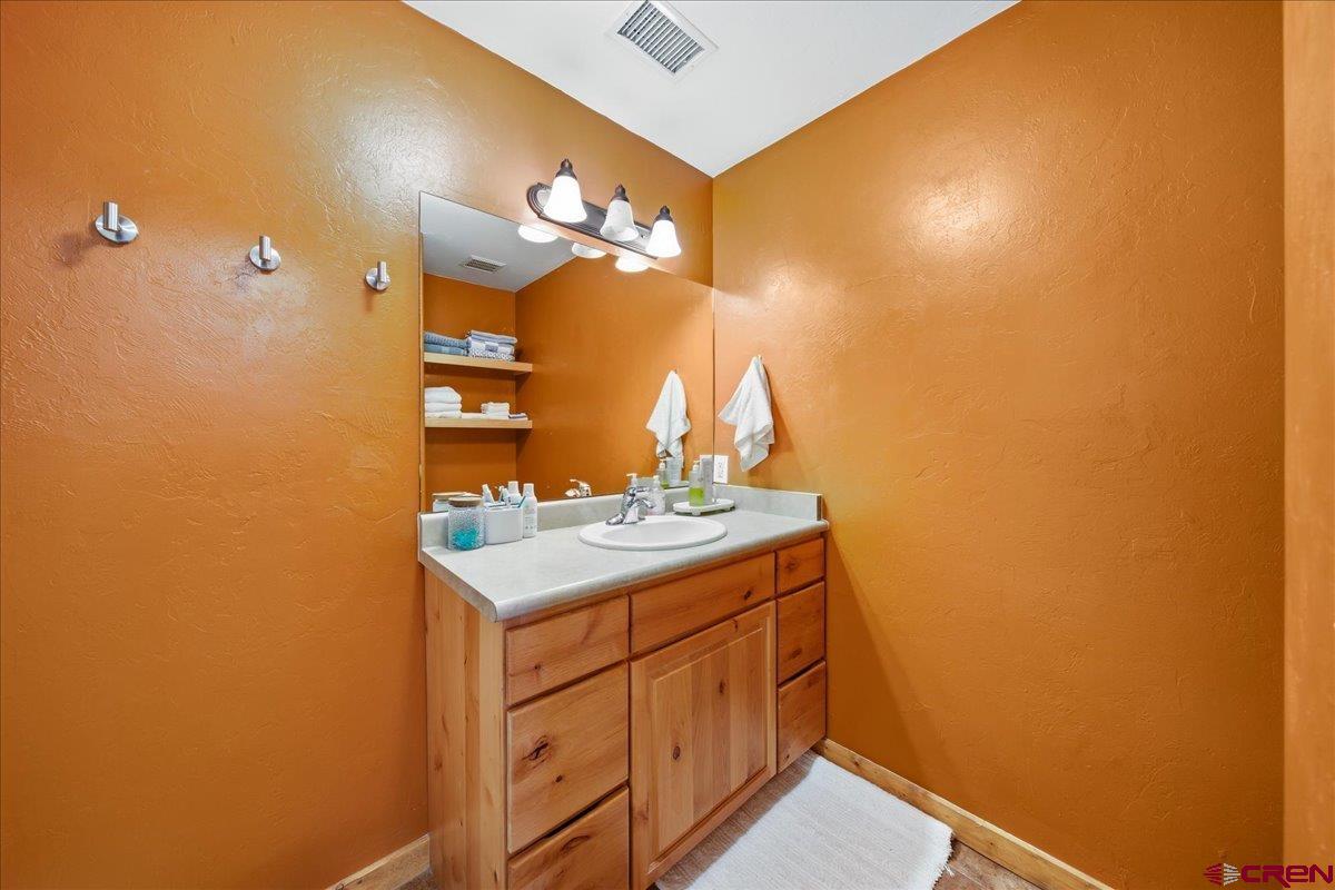 520 Redcliff Circle, Unit G203 Ridgway, CO 81432 - Photo 11 of 25 a bathroom with a sink a vanity and a mirror