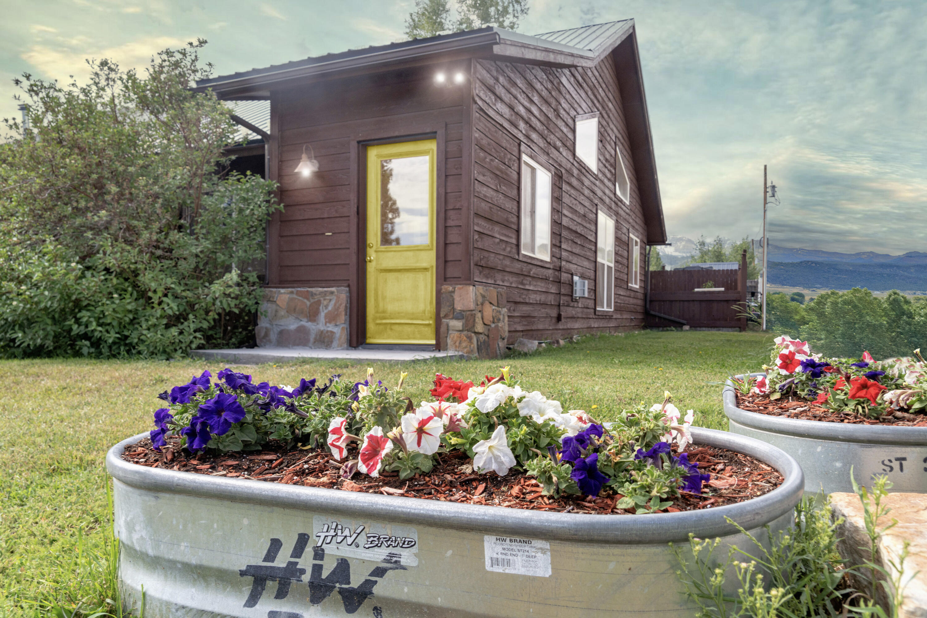 660 Otto Street Ridgway, CO 81432 - Photo 4 of 27 a front view of a house with a yard and flowers
