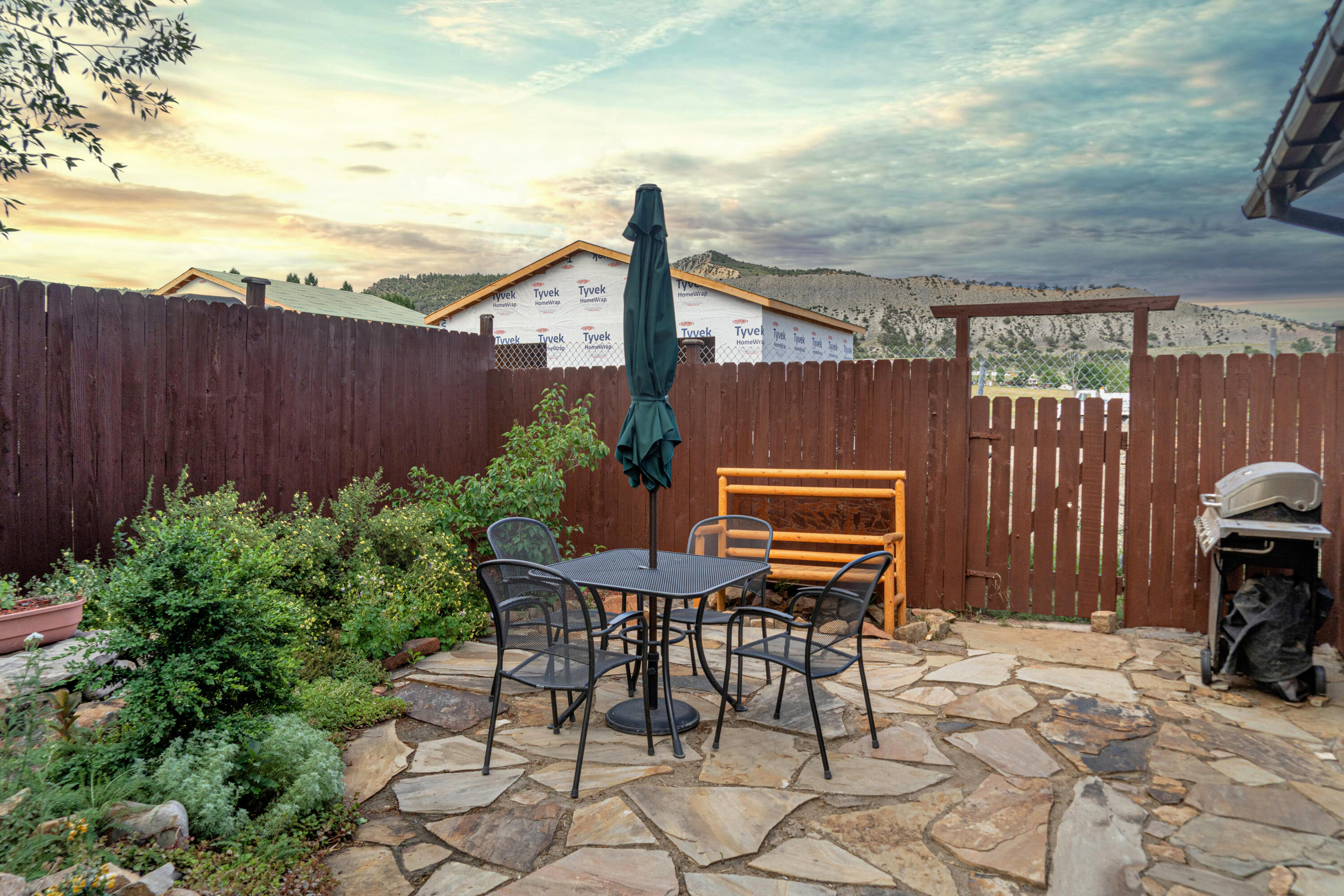 660 Otto Street Ridgway, CO 81432 - Photo 8 of 27 a backyard of a house with barbeque oven table and chairs