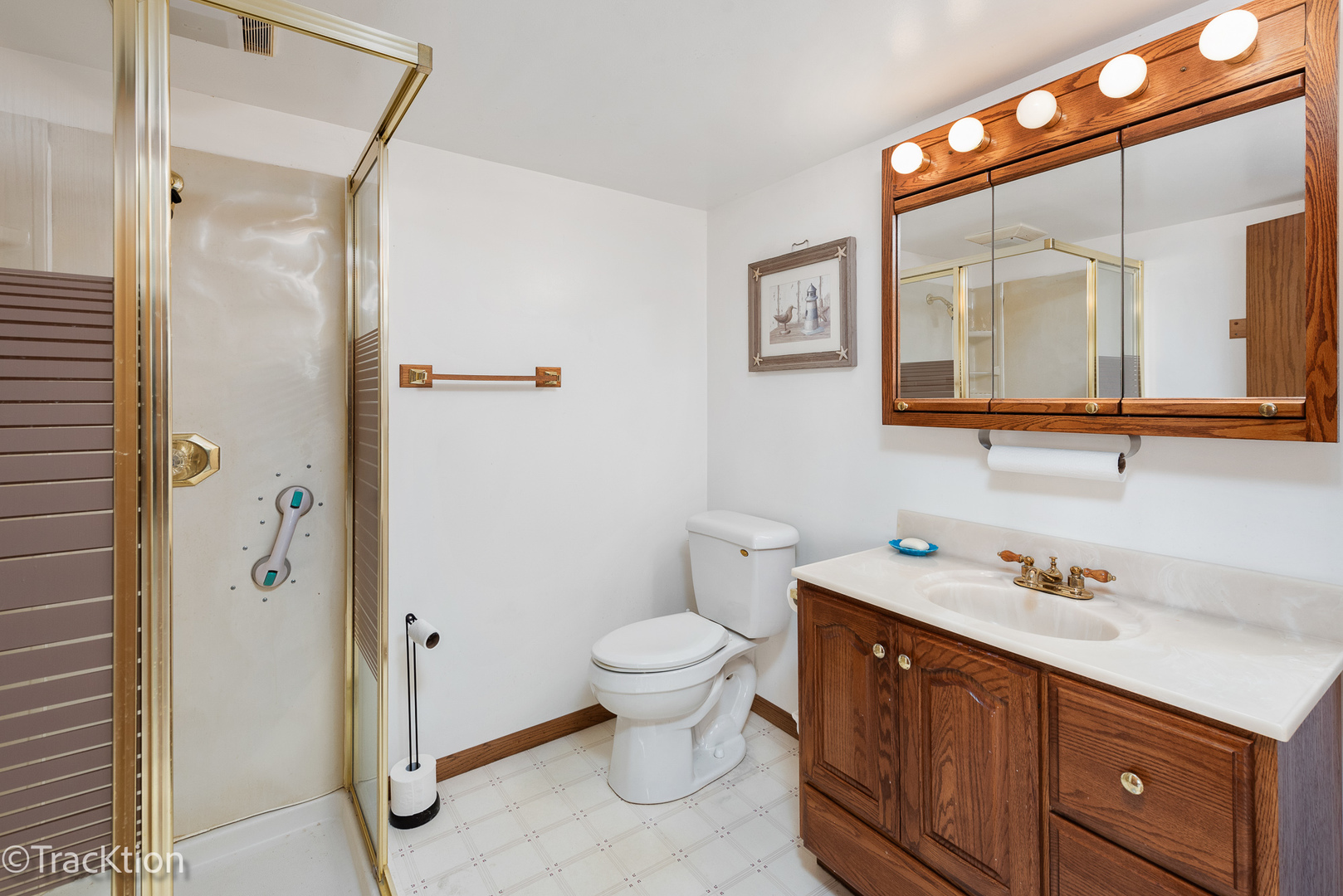 26134 Spring Grove Road Antioch, IL 60002 - Photo 22 of 33 a bathroom with a toilet sink and mirror