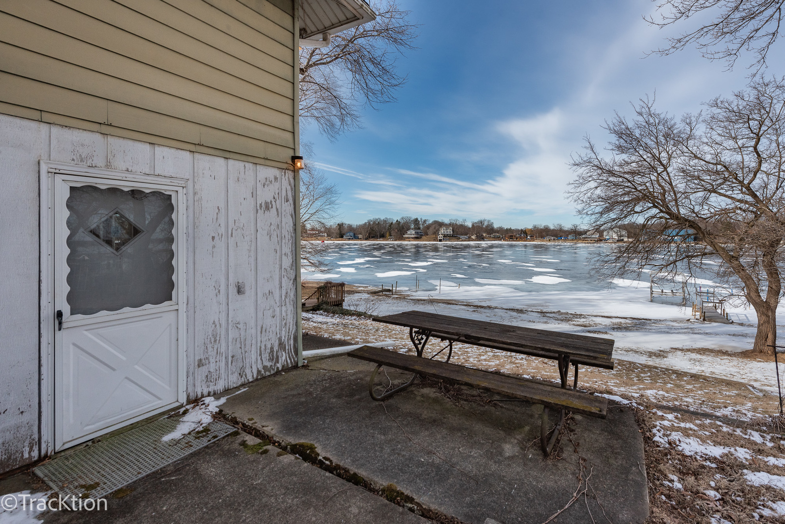 26134 Spring Grove Road Antioch, IL 60002 - Photo 23 of 33 a view of a wooden bench in the back yard of a house