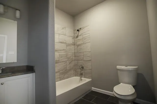 a bathroom with a toilet a sink and bathtub