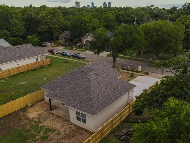 an aerial view of a house having yard and a patio