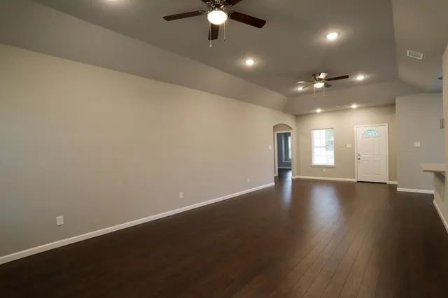 an empty room with a empty space and a ceiling fan