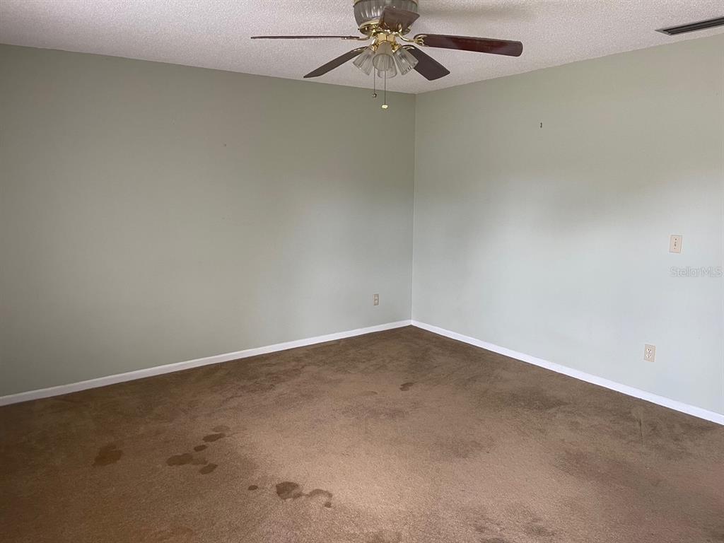 3048 Unity Tree Drive Edgewater, FL 32141 - Photo 2 of 9 an empty room with a fan and a window