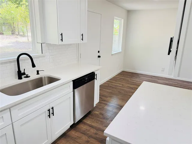 a view of cabinets with wooden floor and window