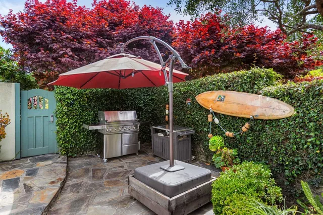 a backyard of a house with table and chairs