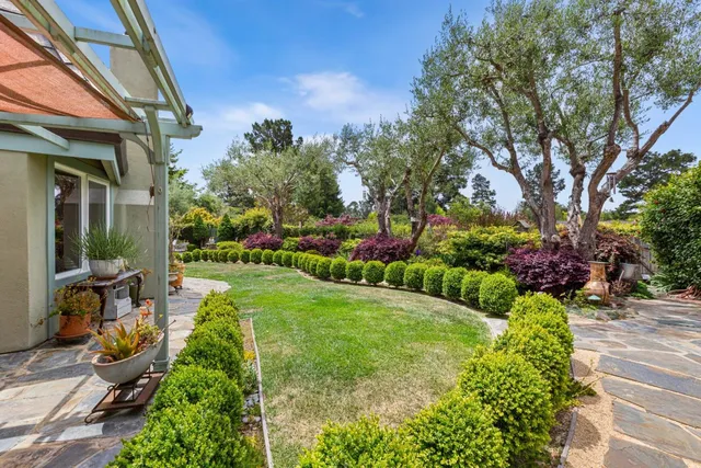 a view of a backyard with sitting area