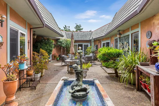 a building outdoor space with patio furniture and potted plants
