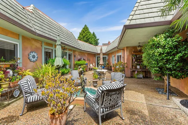 a view of a patio with couches and potted plants