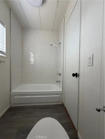 a bathroom with a toilet and a bathtub