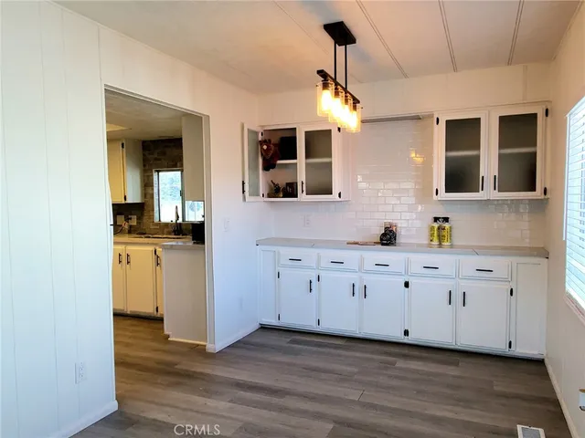 a spacious bathroom with a granite countertop sink mirror and bathtub