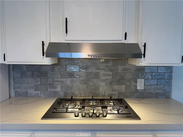 a white stove top oven sitting inside of a kitchen