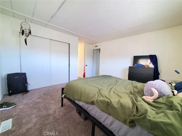 a bedroom with a bed and a chair