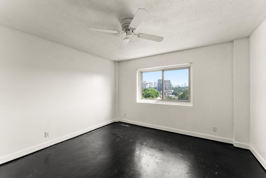 2285 Peachtree Street Northeast, Unit 801 Atlanta, GA 30309 - Photo 11 of 30 an empty room with wooden floor and windows