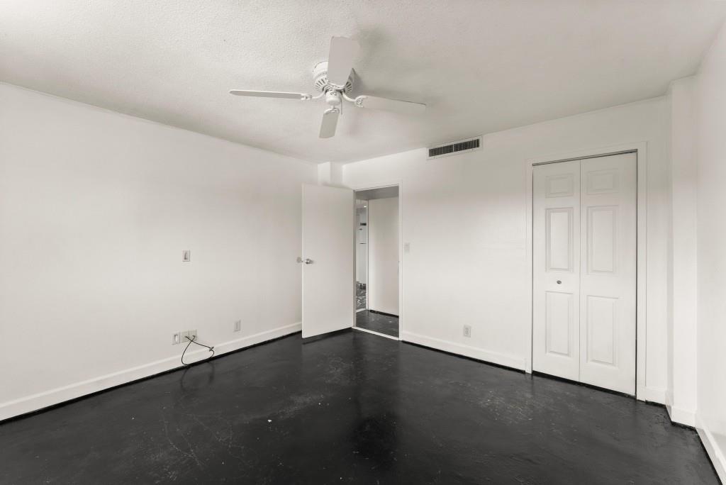 2285 Peachtree Street Northeast, Unit 801 Atlanta, GA 30309 - Photo 13 of 30 an empty room with a ceiling fan and wooden floor